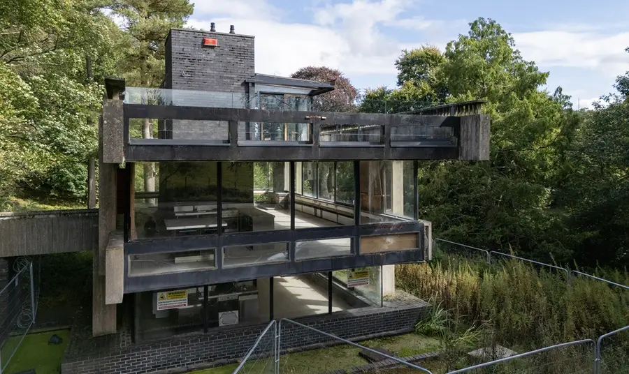 A view of the three levels of the Bernat Klein Studio, a brutalist concrete structure surrounded by woodland.