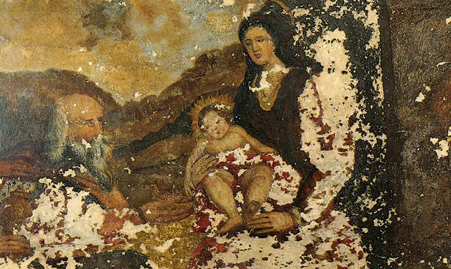 A damaged wall painting showing a biblical scene of the Virgin Mary and infant Christ