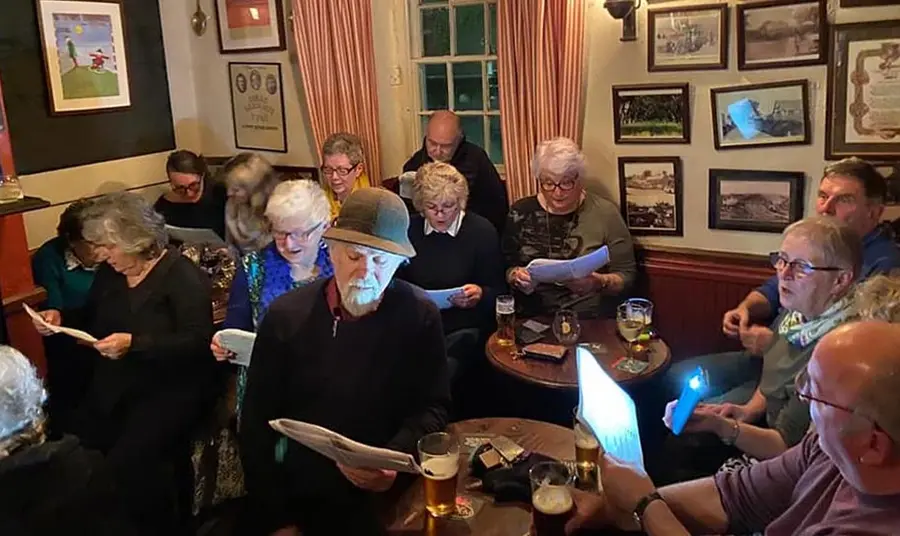 a group of people sitting in a historic Welsh pub