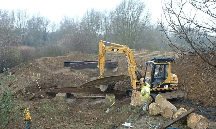 Diggers help to install bridges across the site.
