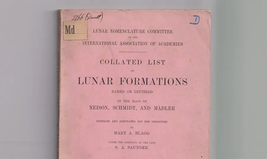 A photograph of a scientific publication titled Collated List of Lunar Formations. The cover page mentions Mary Blagg as the author of the work