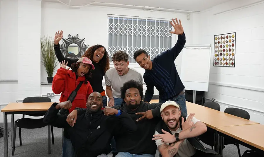 A group of young people posing and smiling