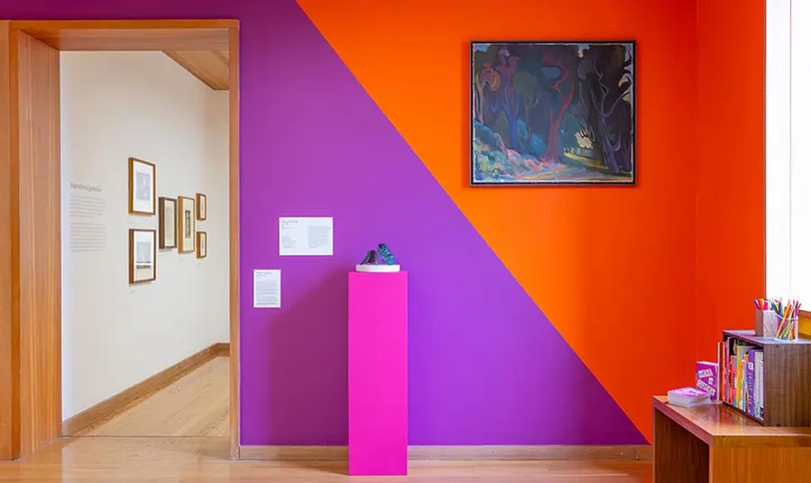 An exhibition space with brightly painted walls