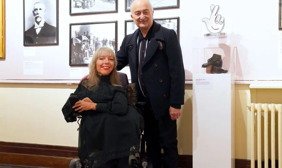 Esther with Tony Robinson stood beside her and the National Lottery award on a plinth next to them