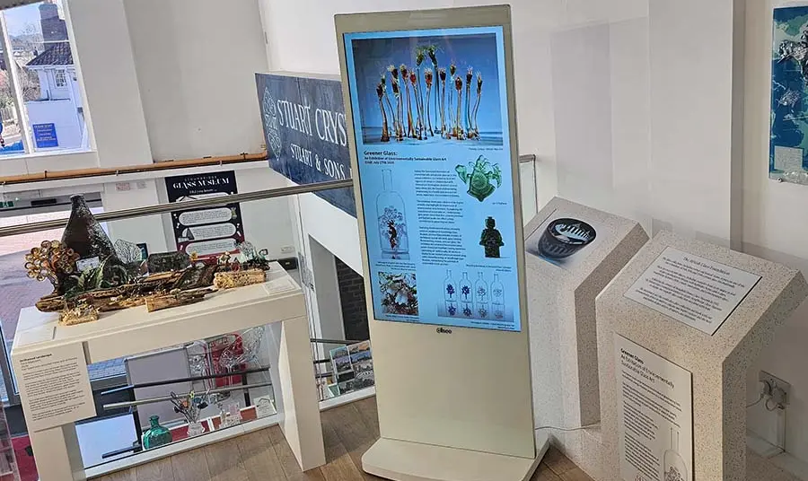 The exhibition space showing display panels and artwork.