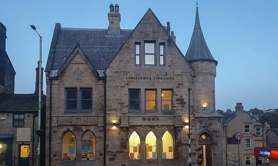 The exterior of an old bank which has been transformed into housing and working spaces