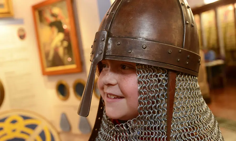 Child wearing a Medieval helmet