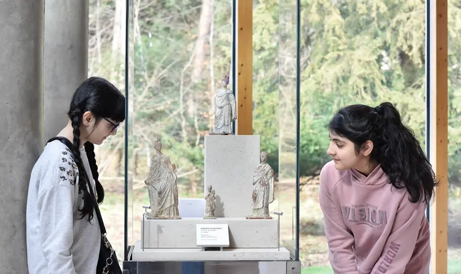 Two children looking at an item in the Burrel collection. Credit: Julie Howden/National Lottery