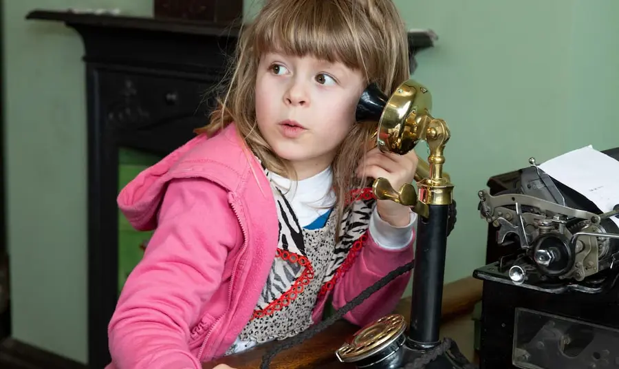 A child using an old-fashioned telephone. Credit Richard Jinman