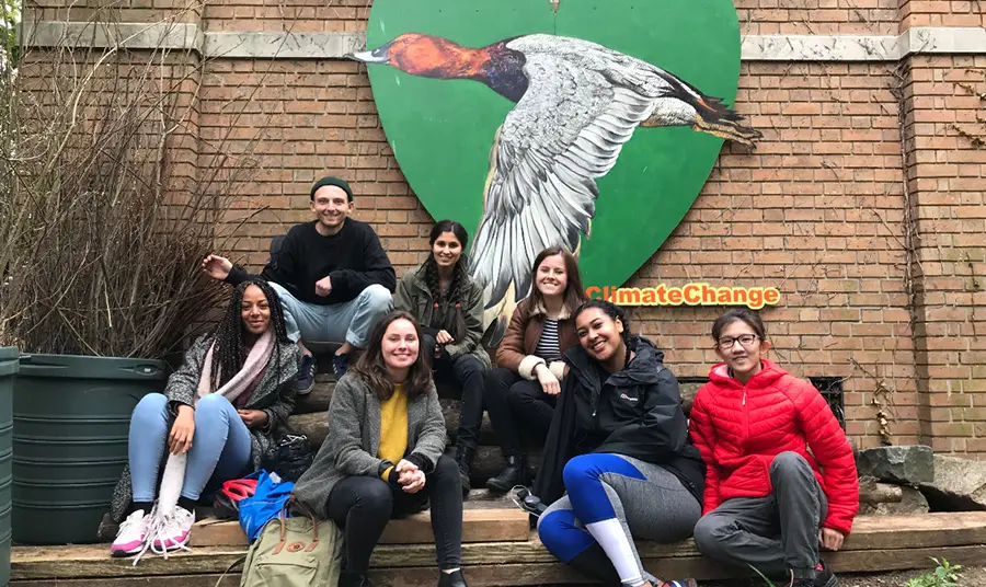 a group of young people pose for a photo outdoors