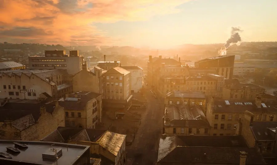 An aerial view across the streets, tenements and former industrial buildings of Little Germany at sunrise.