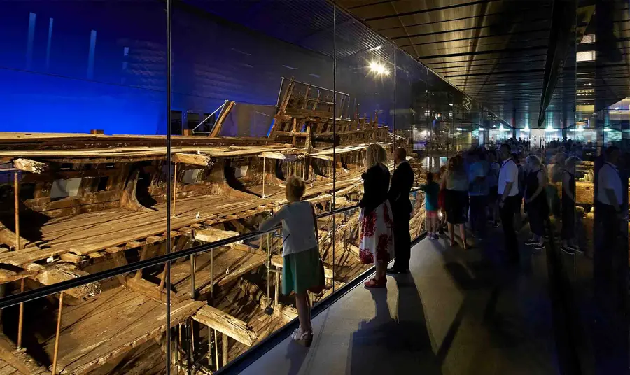 Visitors walk along the pathway to see the Mary Rose ship.