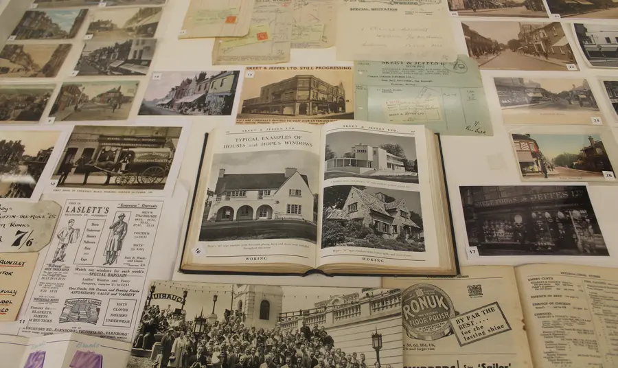 Heritage display for 'Woking's Story' exhibit, a collection of vintage postcards and books