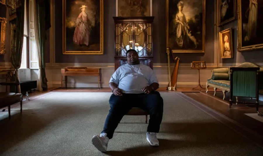 25 years: Stars launch free offers for National Lottery players Big Narstie sitting in Kenwood House