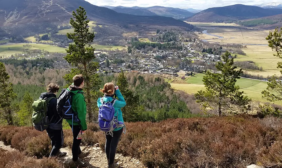 Heritage Horizon Awards Three people look down over a valley with mountains in the distance