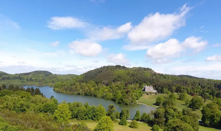 Panoramic view of Castlewellan Forest Park, with lake and castle visible on the hill