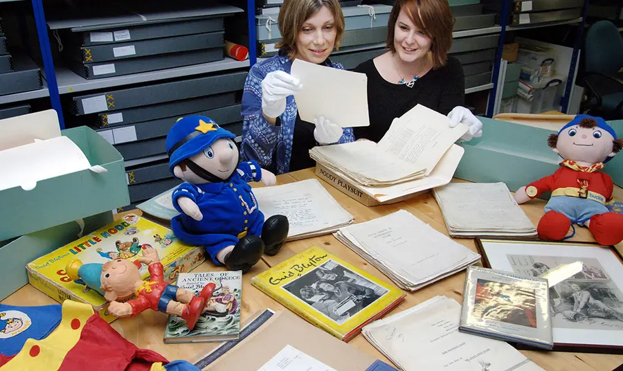 World of books and stories saved by National Lottery Collections Director Sarah Lawrance and Exhibition Manager Alison Fisher with Enid Blyton archive