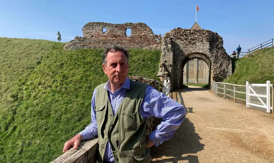 Edward on a sunny day, standing in front of some historical ruins