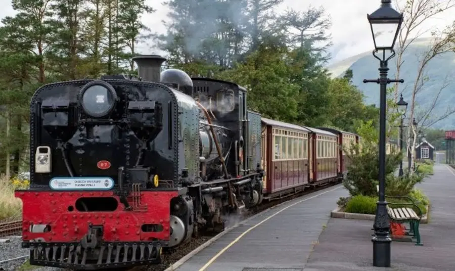 Train pulling into station with bilingual acknowledgement logo on the front