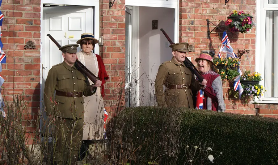 Two men dressed as soldiers standing at their front door