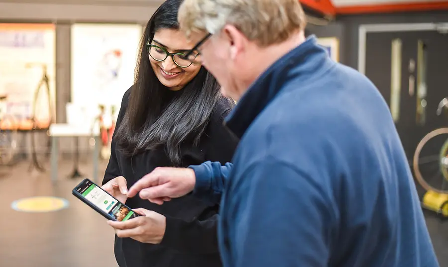 Two people looking at a phone