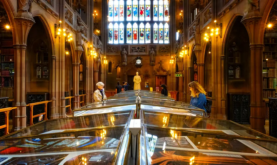 People look at display cases in an old library