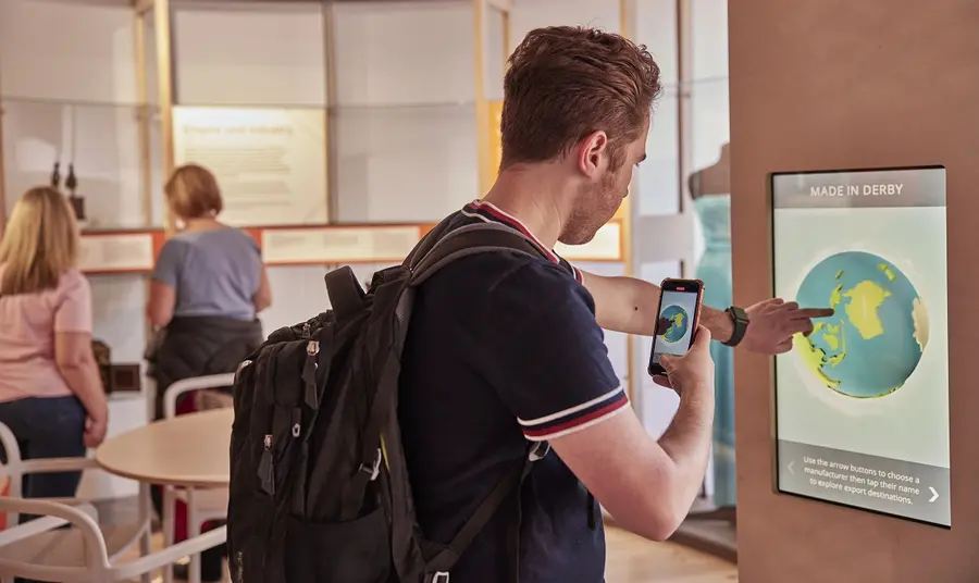 Man taking a picture of himself using a touchscreen at an interactive exhibition