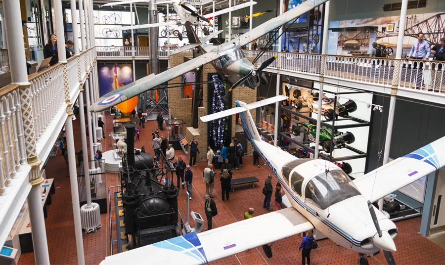 Interior view of the National Museum of Scotland featuring planes suspended from the ceiling