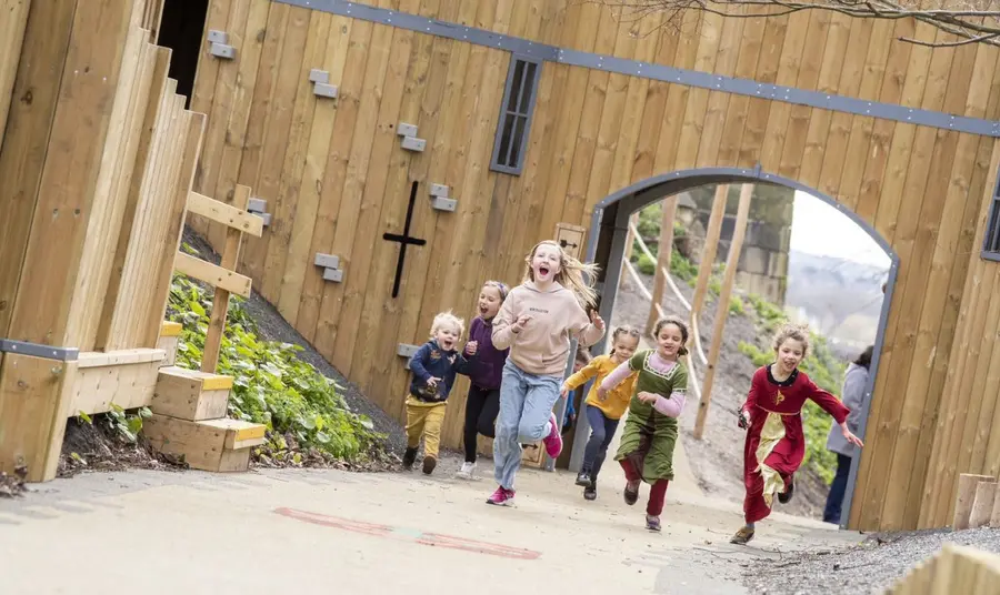 Free offers for National Lottery players at heritage sites across the UK Children running through large arch