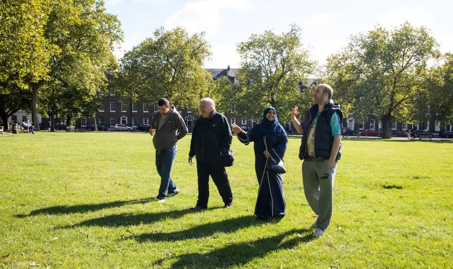 Four people walking through a park