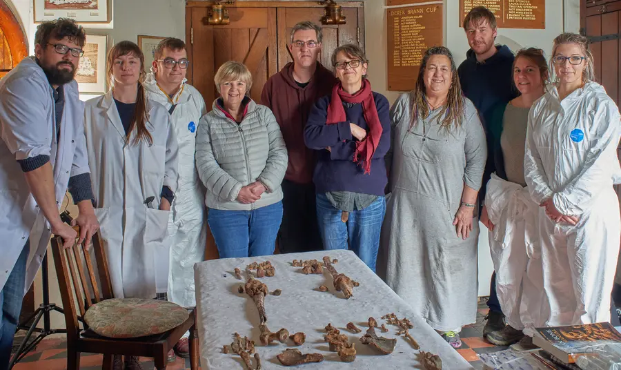 Group stand round skeletal remains