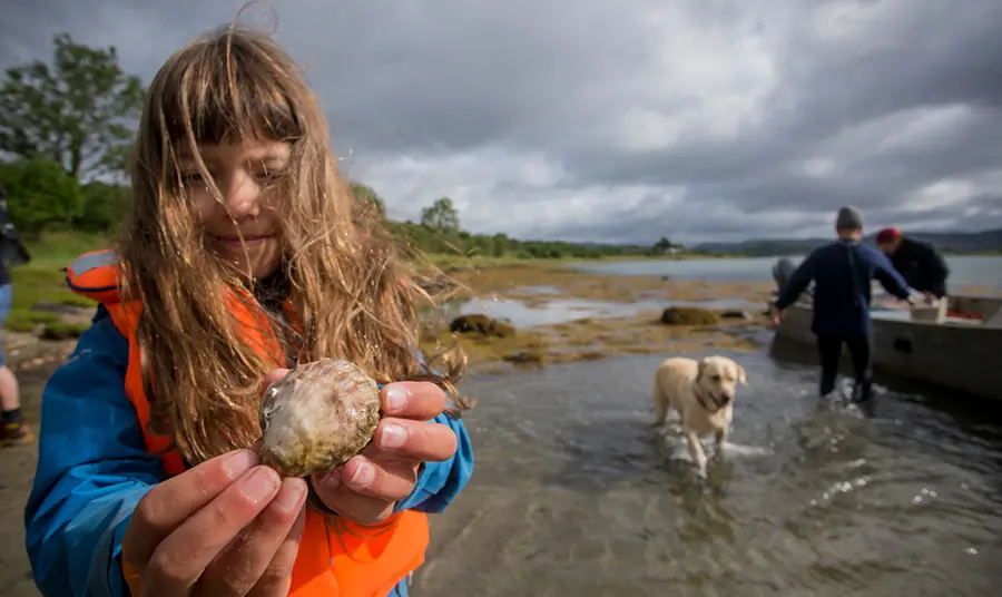 Join us in sharing your #PlanetaryPromise this week Young girl holding an oyster