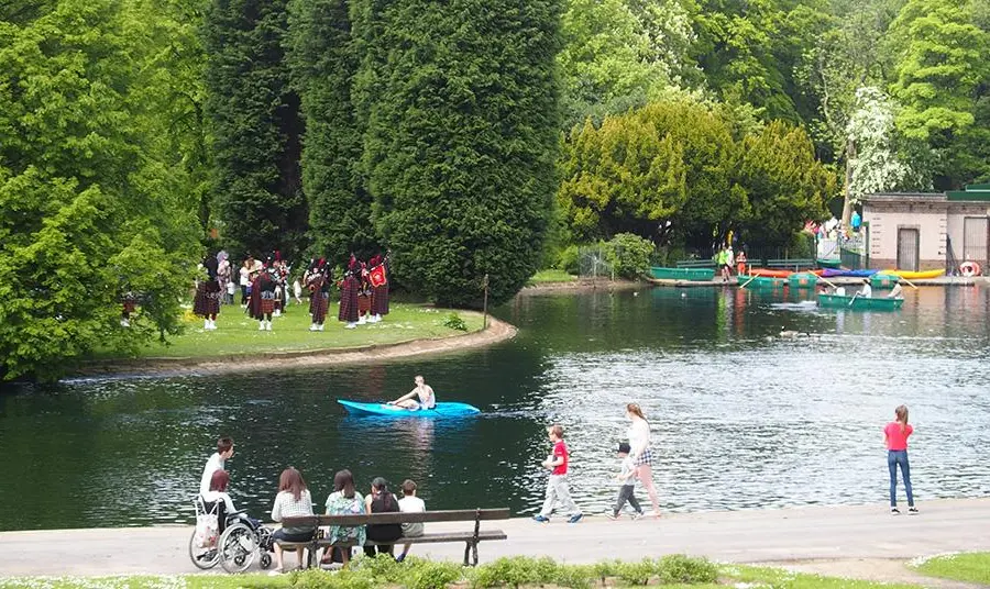Local area guidance Groups of people using a park in a variety of ways, including rowing, listening to music and sitting on a bench