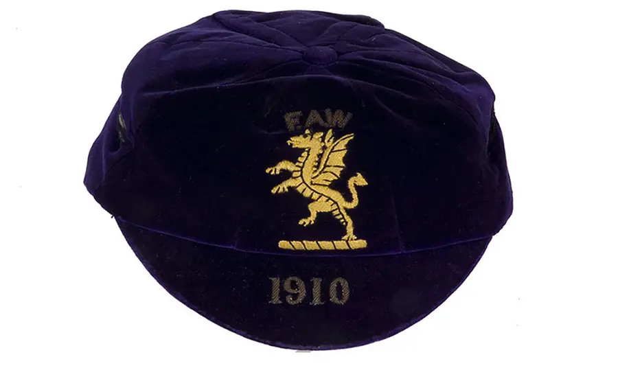 A cap embroidered with a Welsh dragon and the date 1910