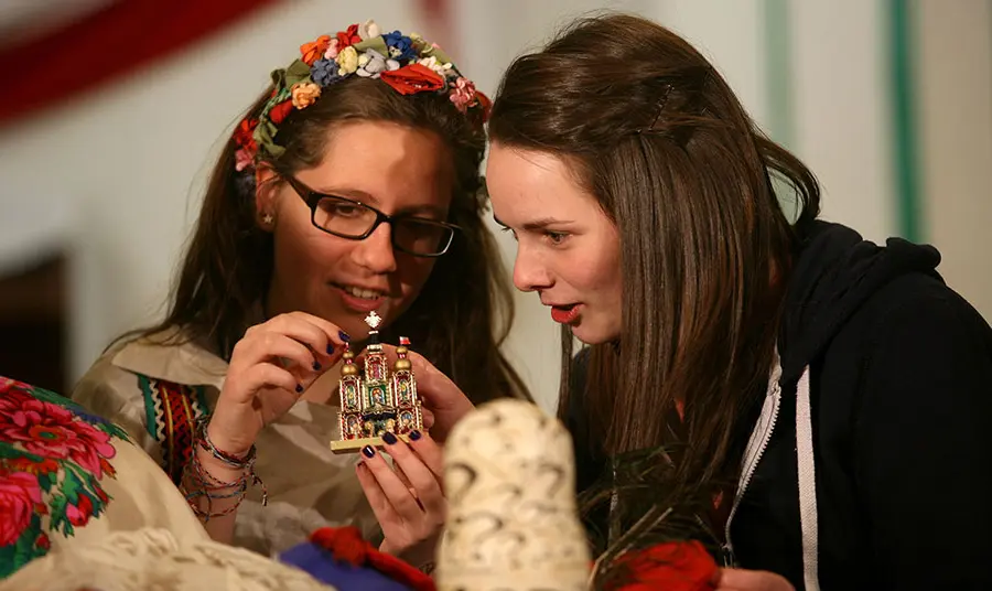 Two young women examining a figurine