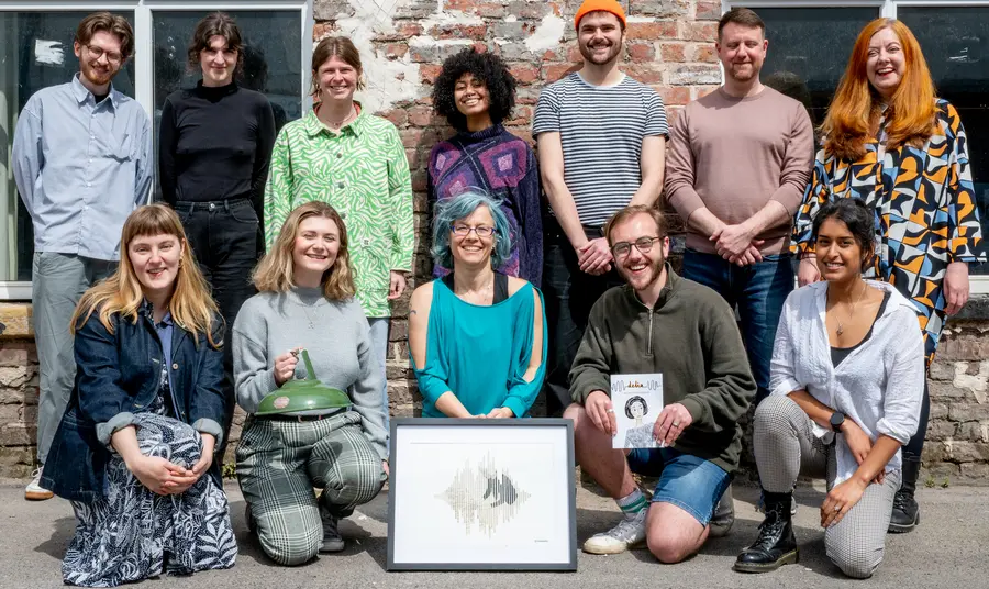 A group of people stand together with the Delia Derbyshire collections