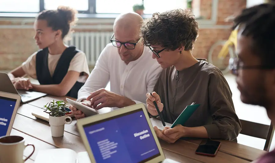 a group of people working together around a table