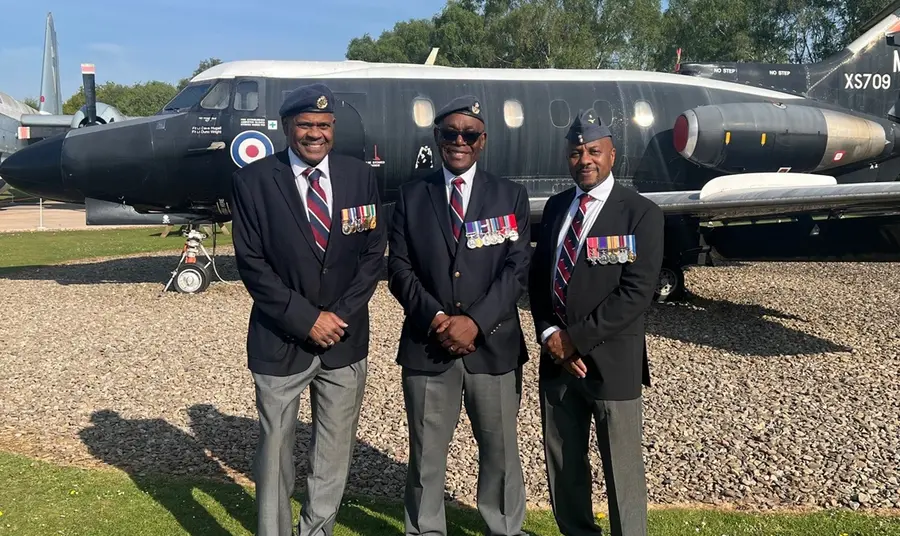 Donald Campbell and two of his fellow veterans stand together in front of a decommissioned RAF plane.
