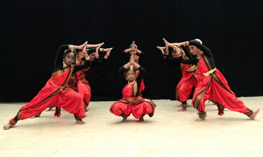 A group of young people perform an Indian classical dance called Bharatanatyam.