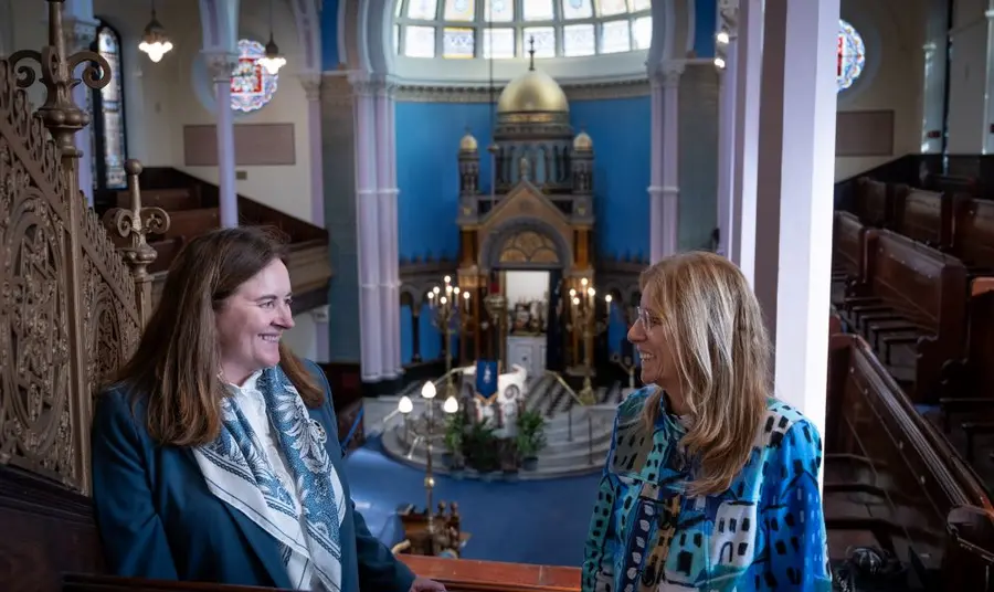 Places of Worship Two people standing on an internal balcony in Glasgow's Garnethill synagogue