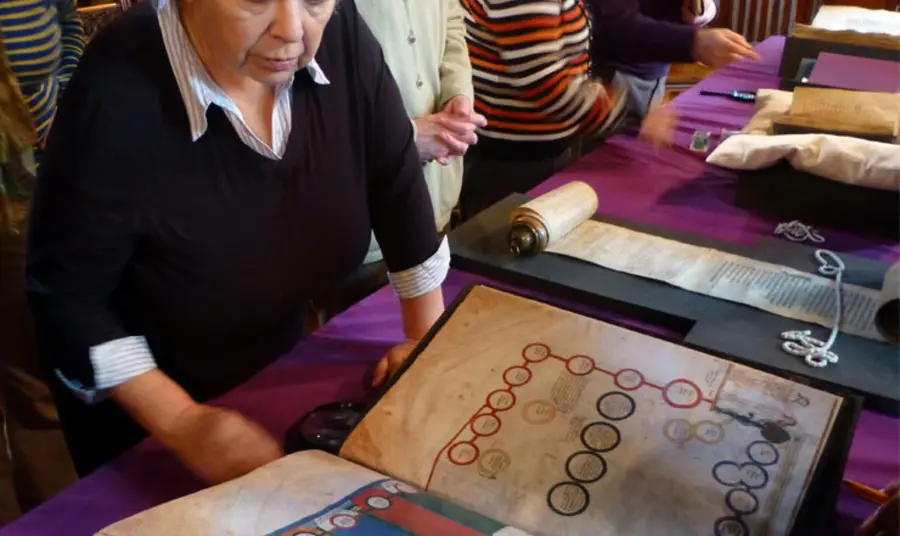 Visitors look at books and manuscripts in the collection