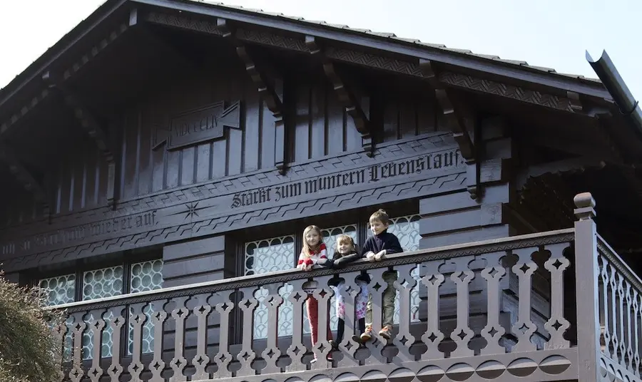 Children on balcony of wooden playhouse