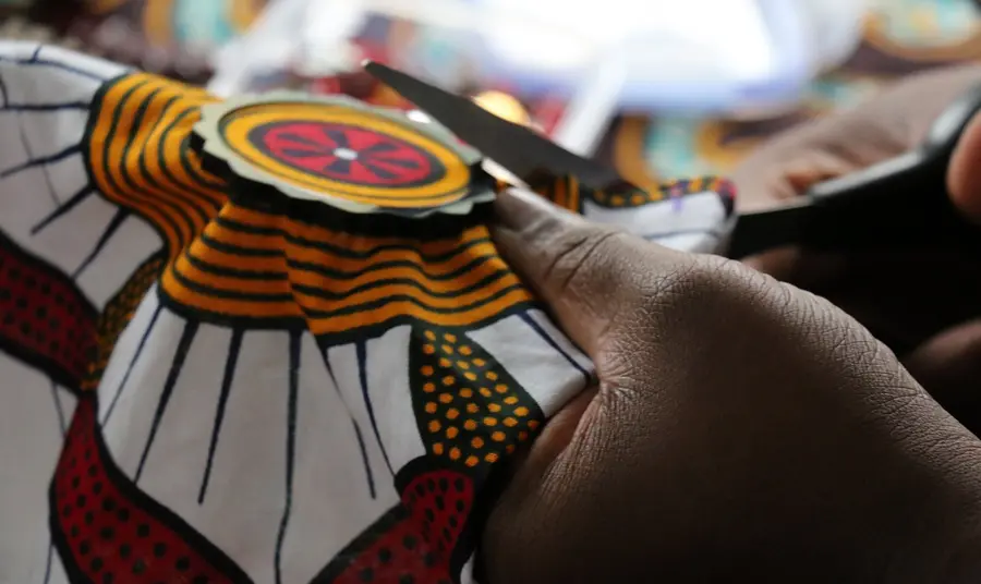 Close up photo of someone sewing at the Bam sistahood project