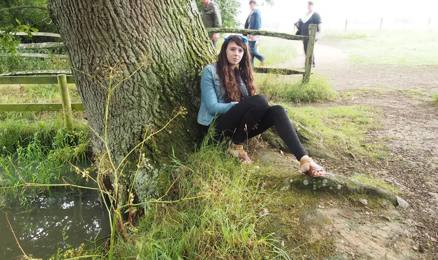 Young woman under tree
