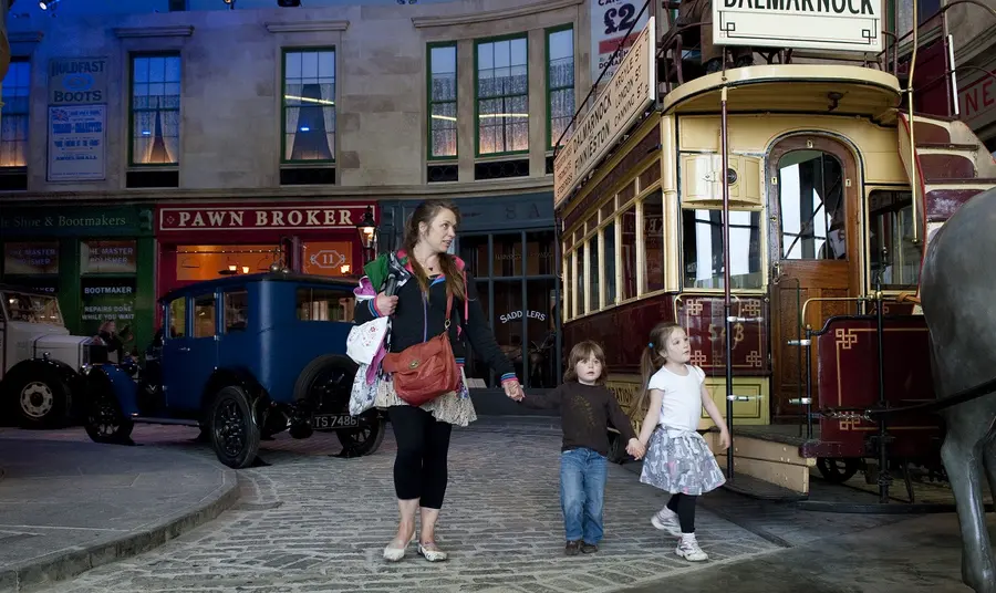 Adult and child walking through Glasgow Museums Resource Centre