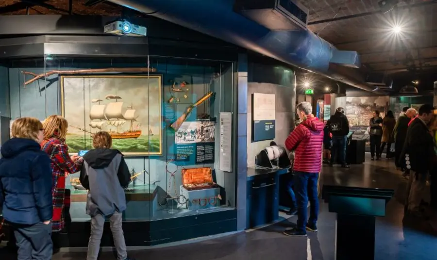 Groups of people looking at exhibits in a maritime museum