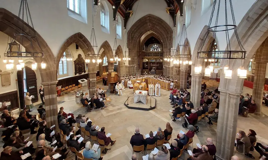 A photo of the inside of Leicester Cathedral during a service, taken from a high perspective within the building