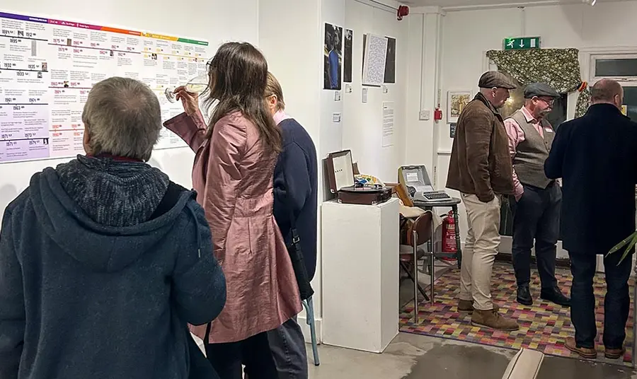 People look at an exhibition of LGBTQ+ people's stories