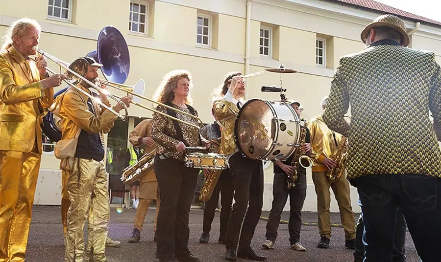 People are together playing instruments outside
