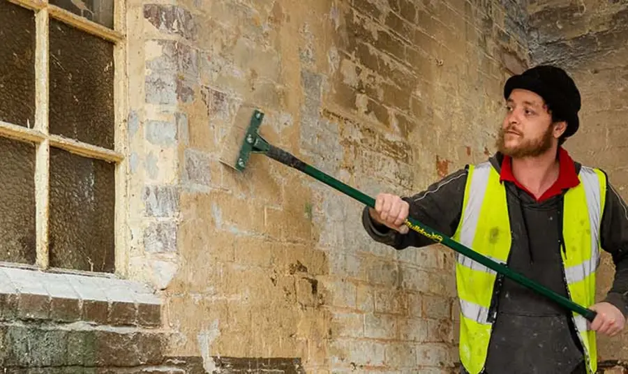 Business Support and Enterprise Development Man fixing old wall